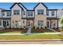 Modern townhomes boasting brick and siding exteriors, lush lawns, and inviting sidewalks for a picturesque community appeal at 3113 Beacon Heights Rd, Indian Land, SC 29707