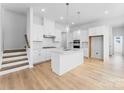 Modern kitchen with white cabinets, center island, stainless steel appliances, and pendant lighting at 3113 Beacon Heights Rd, Indian Land, SC 29707