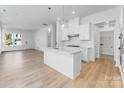 Bright, open kitchen with a center island, seamlessly flowing into the living space at 3113 Beacon Heights Rd, Indian Land, SC 29707