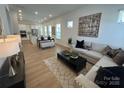 Inviting living room with modern decor, a stylish sofa, a large coffee table, and abundant natural light at 3113 Beacon Heights Rd, Indian Land, SC 29707