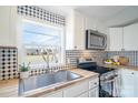 Charming kitchen featuring stainless appliances, butcher block counters, and stylish backsplash at 3416 Polkville Rd, Shelby, NC 28150