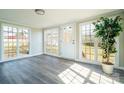 Bright sunroom featuring large windows, modern flooring, and a rear door entrance at 3416 Polkville Rd, Shelby, NC 28150