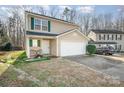 Two-story house with attached garage and stone walkway leading to the front door at 509 Tallwood Ct, Charlotte, NC 28216