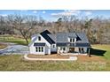 Aerial view of a white farmhouse on a spacious lot with trees at 535 Grampian Rd, Mt Ulla, NC 28125