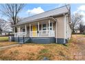 House exterior showcasing a yellow front door and gray siding at 639 Harrison St, Statesville, NC 28677