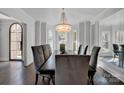 Elegant dining room featuring a large chandelier and bay window at 7704 Seton House Ln, Charlotte, NC 28277