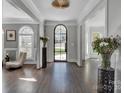 Bright entryway with hardwood floors, arched doorway and decorative accents at 7704 Seton House Ln, Charlotte, NC 28277