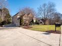 Two-story house with a large driveway and manicured lawn at 7704 Seton House Ln, Charlotte, NC 28277