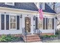 Welcoming entrance with brick steps, decorative railing, and a glass storm door at 7832 Winterset Dr, Charlotte, NC 28270