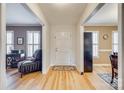 Inviting hallway with hardwood floors leading to multiple rooms with natural light at 7832 Winterset Dr, Charlotte, NC 28270