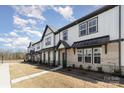 Row of townhomes showcasing consistent design, landscaping, and a clean streetscape at 8928 Morning Mist Rd, Charlotte, NC 28215