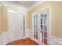 Bright entryway with hardwood floors and French doors at 10318 Threatt Woods Dr, Charlotte, NC 28277