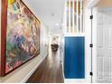 Bright hallway with hardwood floors and large artwork at 11532 Delores Ferguson Ln # 1004, Charlotte, NC 28277