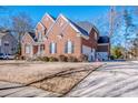 Brick home with a side view showing a driveway and attached garage at 11925 Lawings Corner Dr, Huntersville, NC 28078