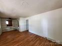 Bright living room featuring hardwood floors and built-in shelving at 1418 Winston Dr, Charlotte, NC 28205