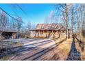 Log cabin home with a spacious yard and detached garage at 148 Shawver Ln, Statesville, NC 28625