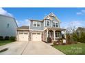 Two-story house with gray siding, stone accents, and a two-car garage at 1585 Whitman Ct, York, SC 29745