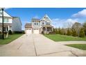 Two-story house with gray siding, stone accents, and a two-car garage at 1585 Whitman Ct, York, SC 29745