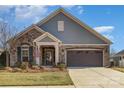 Beautiful ranch home with stone accents and a two-car garage at 1608 Traditions Ct, Waxhaw, NC 28173