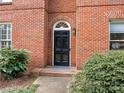 Black front door with arched transom window, brick facade at 2031 Queens W Rd, Charlotte, NC 28207