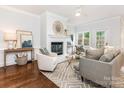 Spacious living room with fireplace, hardwood floors, and neutral decor at 2031 Queens W Rd, Charlotte, NC 28207