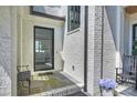 Side entrance with a modern black door and a stone patio at 2714 Selwyn Ave, Charlotte, NC 28209