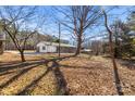 Spacious backyard with mature trees and a chain link fence at 322 Timber Rd, Iron Station, NC 28080