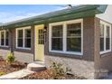 Charming yellow front door and gray brick exterior at 322 Timber Rd, Iron Station, NC 28080