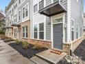 Front entrance of townhome, gray door, brick accents at 4027 Capital Ridge Ct # 10, Charlotte, NC 28205