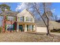 Two-story house with a brick and vinyl exterior, a covered porch, and a two-car garage at 502 Long Creek Pkwy, Charlotte, NC 28214