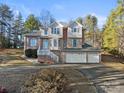 Two-story brick house with a three-car garage, front porch and wooded backyard at 5774 Crown Ter, Hickory, NC 28601