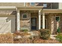 Front entry of townhome with brick exterior and bench at 6014 Cadence Ln, Fort Mill, SC 29707