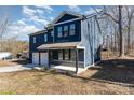 Two-story house with dark blue siding, white garage door, and a stone accent at 619 Norland Ave, Kannapolis, NC 28083