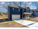 Two-story house with dark blue siding, white garage door, and a stone accent at 619 Norland Ave, Kannapolis, NC 28083