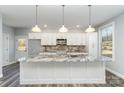 Modern kitchen with white cabinets, granite countertops, and stainless steel appliances at 619 Norland Ave, Kannapolis, NC 28083