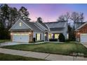 Cozy one-story house with gray siding, stone accents, and a two-car garage at 629 Cordova Ct, Salisbury, NC 28146