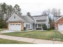 Charming one-story home with gray siding, stone accents, and a two-car garage at 629 Cordova Ct, Salisbury, NC 28146