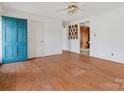 Living room featuring hardwood floors and teal door at 6439 Montpelier Rd, Charlotte, NC 28210