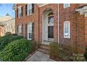 Inviting front entry with a black door and brick columns at 6700 Fairhope Ct, Charlotte, NC 28277