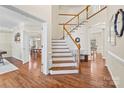 Elegant staircase with hardwood floors and white railings at 6700 Fairhope Ct, Charlotte, NC 28277