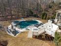 Large kidney shaped pool with a hot tub, deck, and landscaping at 680 Chase Ct, Fort Mill, SC 29708