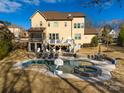 Luxury backyard oasis with a freeform pool, spa, and ample patio space at 680 Chase Ct, Fort Mill, SC 29708