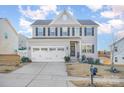 Two-story house with gray siding, white trim, and a three-car garage at 7067 Waterwheel Sw St, Concord, NC 28025