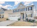 Two-story house with gray siding, white trim, and a three-car garage at 7067 Waterwheel Sw St, Concord, NC 28025