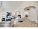 Open living room with vaulted ceilings and a view into the kitchen at 7137 Windyrush Rd, Charlotte, NC 28226