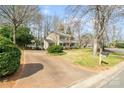 A spacious driveway leads up to this home, nestled among mature trees and a well-manicured lawn at 761 Summerwood Dr, Rock Hill, SC 29732