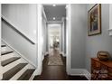 Bright entry hallway with hardwood floors, staircase, and view to the dining area at 7908 Rea View Ct, Charlotte, NC 28226