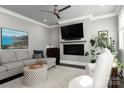 Living room with fireplace, large TV, comfortable seating, and hardwood floors at 7908 Rea View Ct, Charlotte, NC 28226