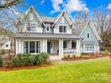 Beautiful two-story home with a covered porch and landscaped yard at 832 Heather Ln, Charlotte, NC 28209