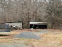 Detached garage and storage shed with a trampoline in the backyard at 10704 Connell Rd, Mint Hill, NC 28227